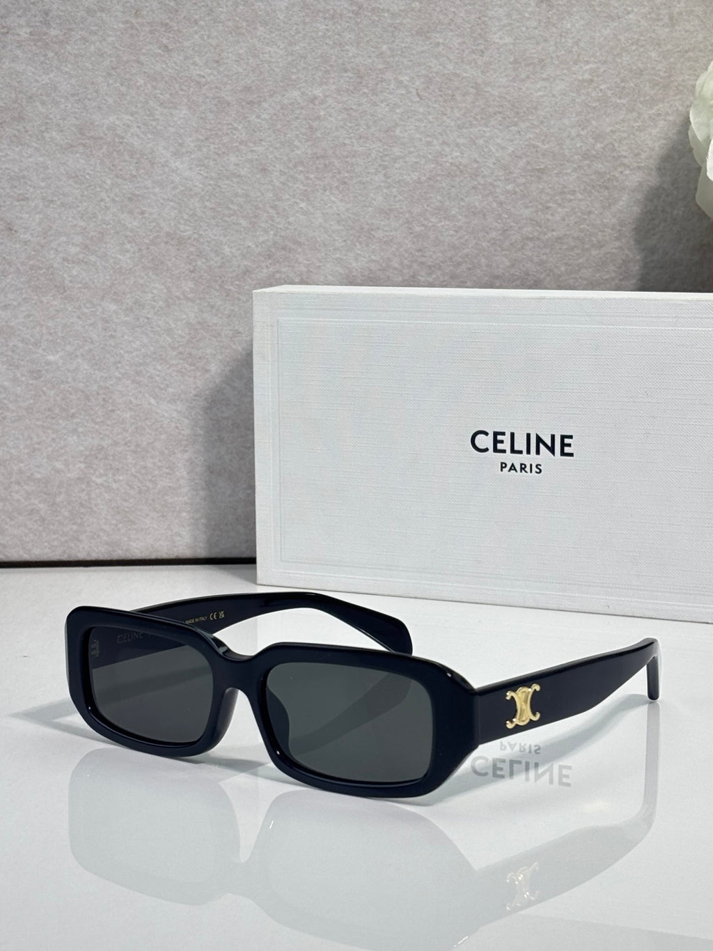 Celine sunglasses with dark navy frame, oversized square lenses, and gold logo