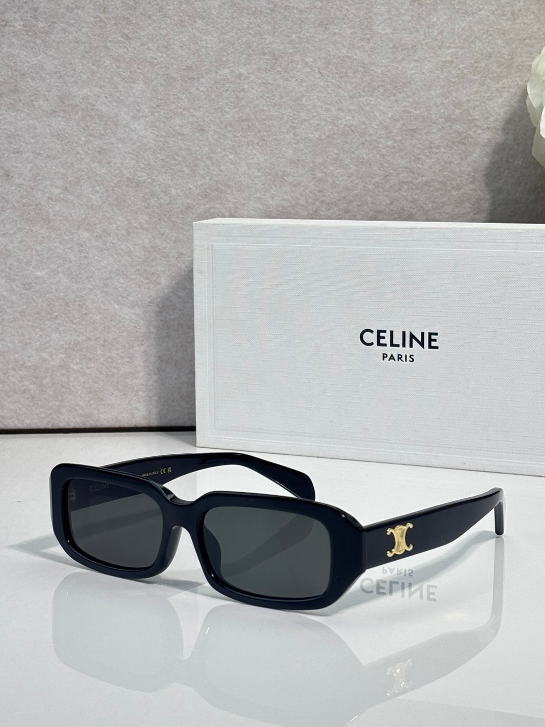 Celine sunglasses with dark navy frame, oversized square lenses, and gold logo