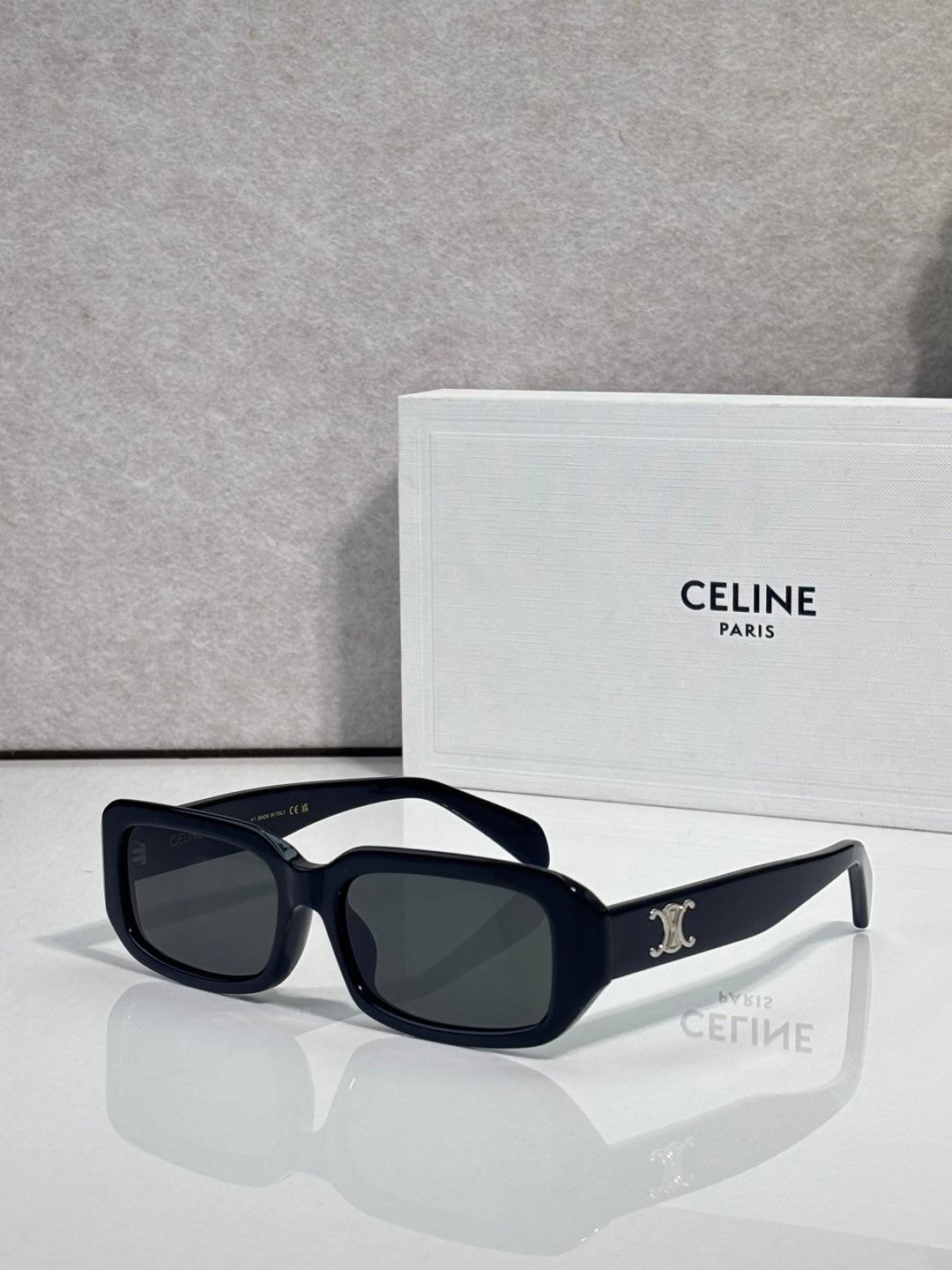 Celine sunglasses with dark frame, black lenses, square shape, and logo detail