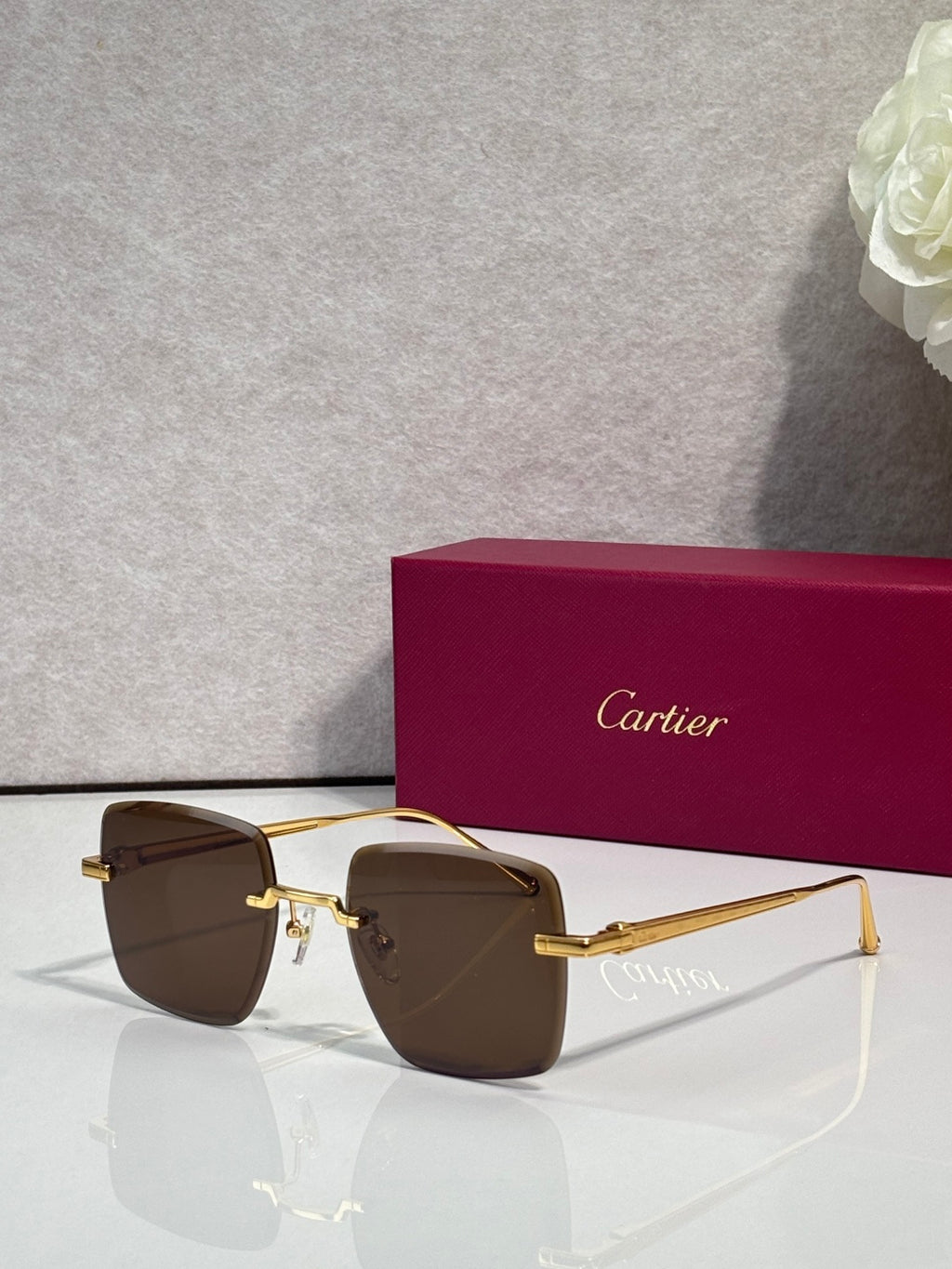 Cartier optical glasses with gold metal frame and dark brown-tinted lenses