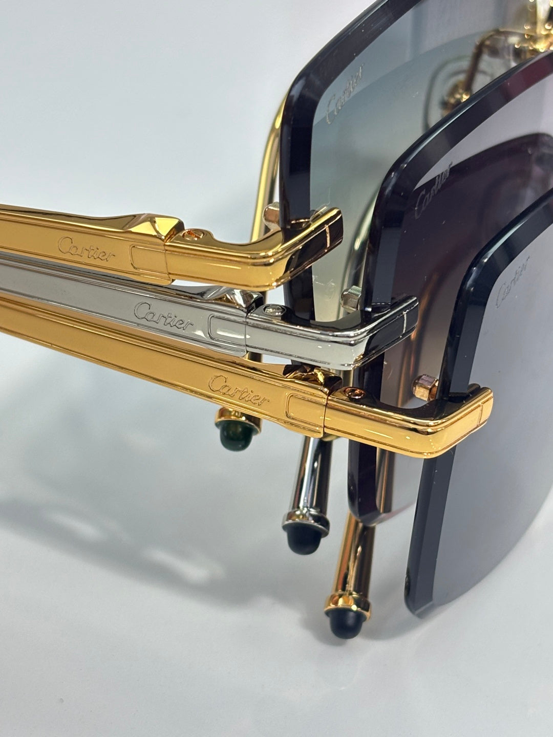 Cartier optical glasses close-up: gold hinges and temples with Cartier engraving