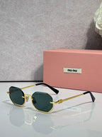 MiuMiu sunglasses with gold frame, green tinted lenses, rounded butterfly shape