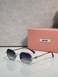 MiuMiu sunglasses with gold frame, dark gray lenses, rounded butterfly shape