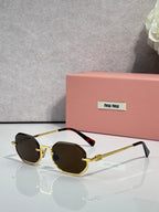 MiuMiu sunglasses with gold frame, dark brown lenses, rounded butterfly shape