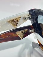 Multi-color cat-eye sunglasses with gold Prada-engraved triangular side details