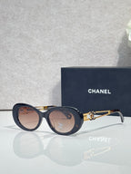Dark blue round sunglasses with gold double-C temple and smoky tinted lenses