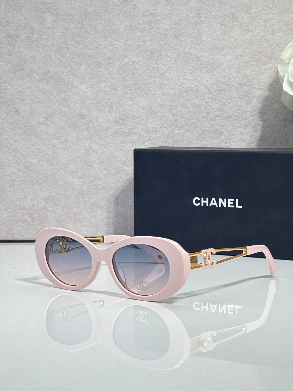 Light pink round sunglasses with gold double-C temple detail and tinted lenses