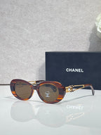 Tortoise round sunglasses with gold double-C temple and amber tinted lenses