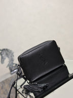 YSL leather crossbody bag in black pebbled finish with YSL logo on the flap.