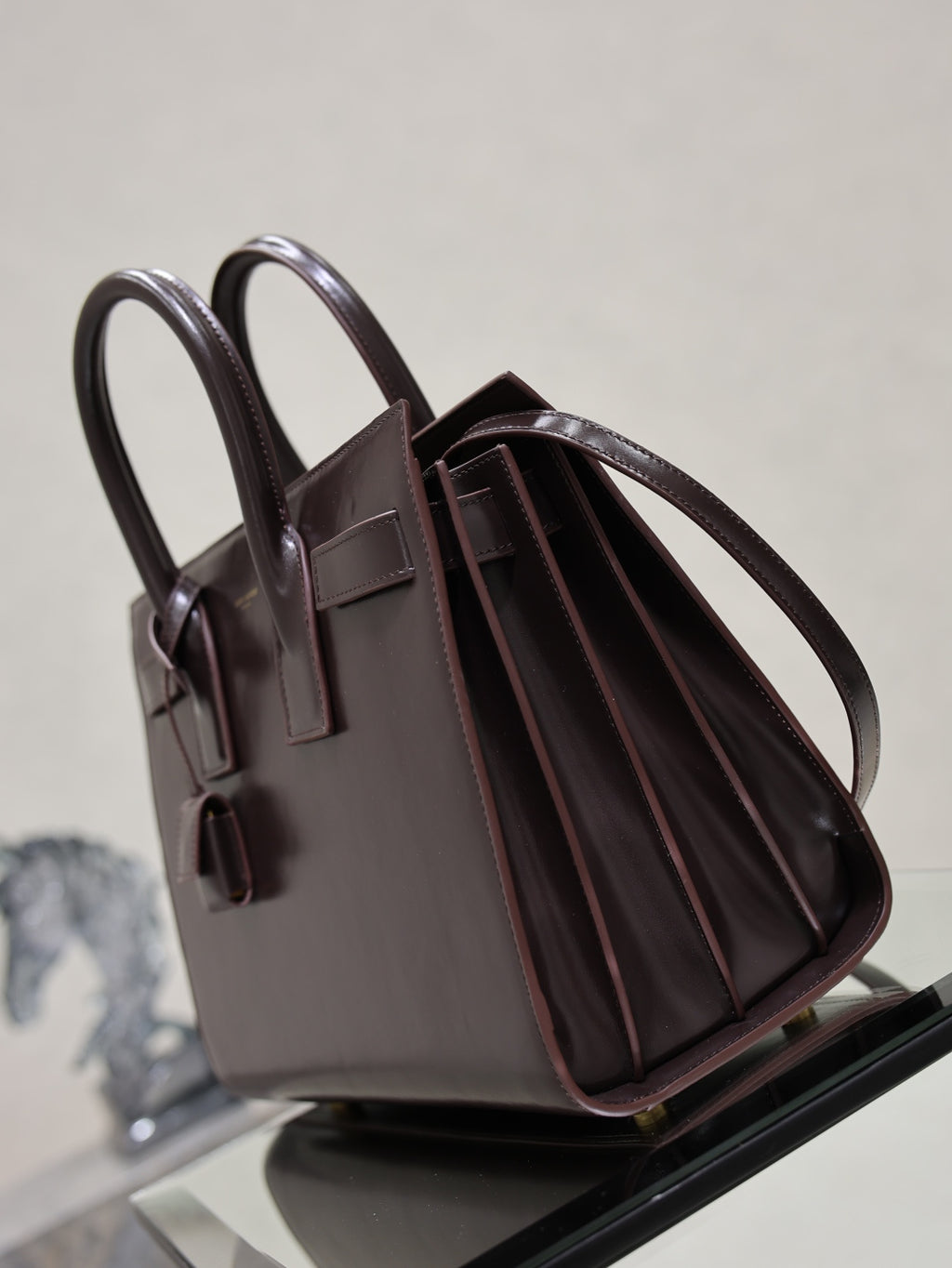 YSL dark brown leather tote bag with open top and striped interior lining