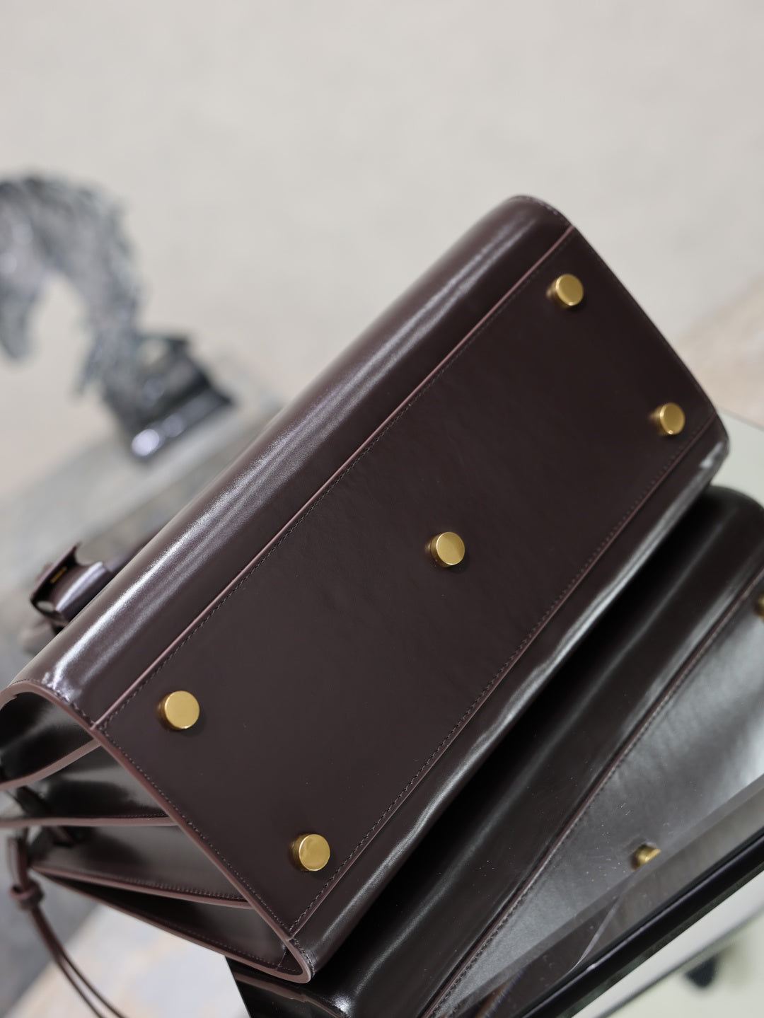 YSL dark brown leather bag with gold-tone stud buttons and side panel detail