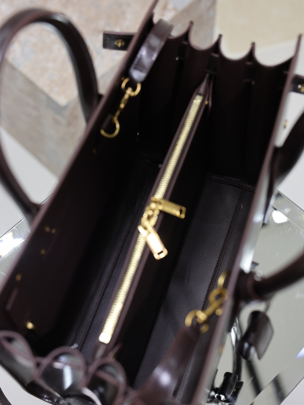 YSL tote bag interior with gold-tone zipper and hanging hardware
