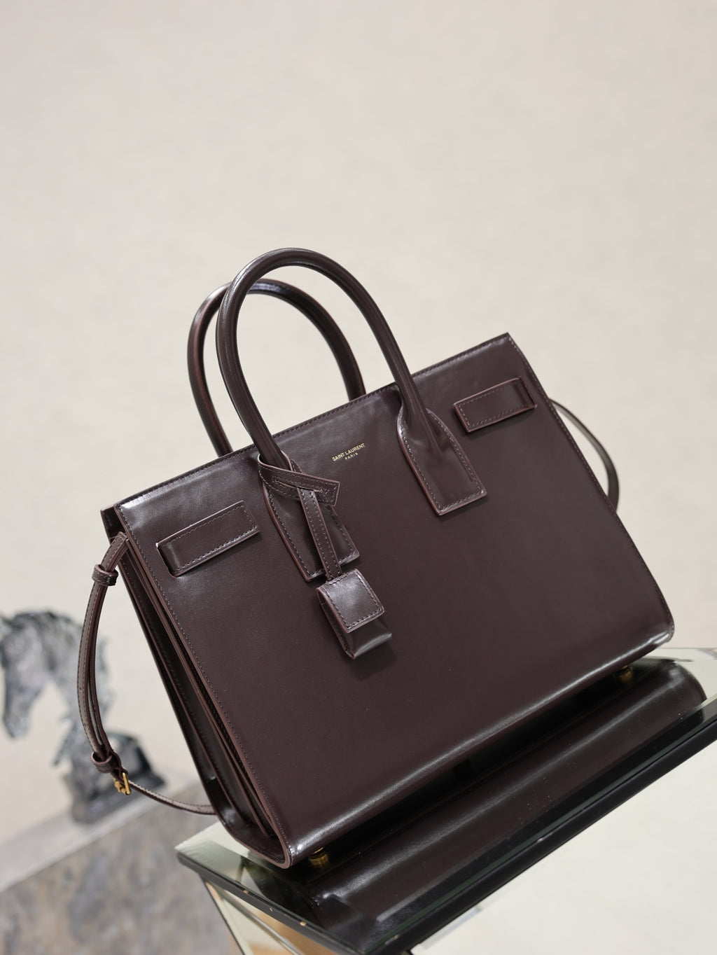 YSL dark brown leather tote bag, front and side view with buckle strap accents