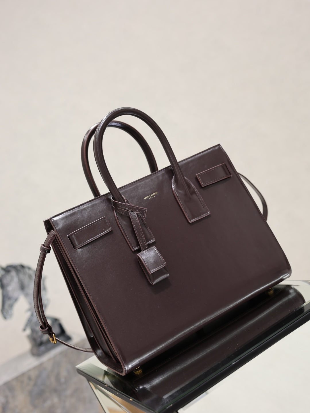 YSL dark brown leather tote bag, front and side view with buckle strap accents
