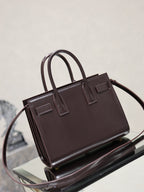 Dark brown YSL tote bag with top handles and front rectangular tab detail