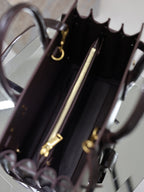 Dark brown YSL tote bag interior with zip pocket, lining, and gold hardware