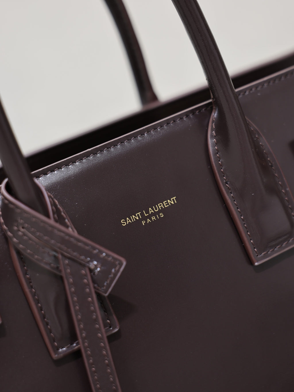 Dark brown YSL tote bag inner pocket with “SAINT LAURENT PARIS” logo detail