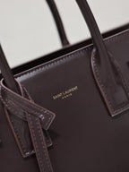 Dark brown YSL tote bag inner pocket with “SAINT LAURENT PARIS” logo detail