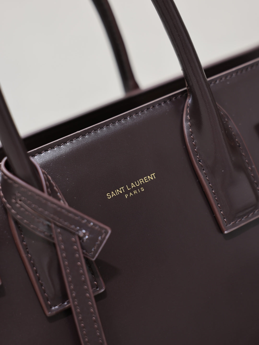 Dark brown YSL tote bag inner pocket with “SAINT LAURENT PARIS” logo detail