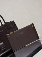 Dark brown YSL tote bag with matching pouch, gold snaps, and front leather tabs