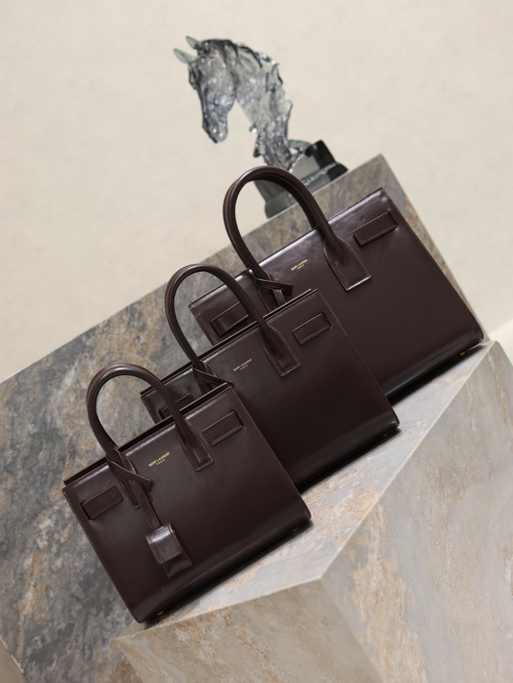 YSL leather tote bag set with front flap and top handles, dark brown.