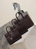 YSL leather tote bag set with front flap and top handles, dark brown.