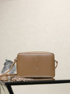 YSL leather crossbody bag in tan with embossed YSL logo and top zipper.