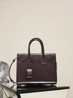 Dark brown YSL tote bag with top handles and front patch pockets