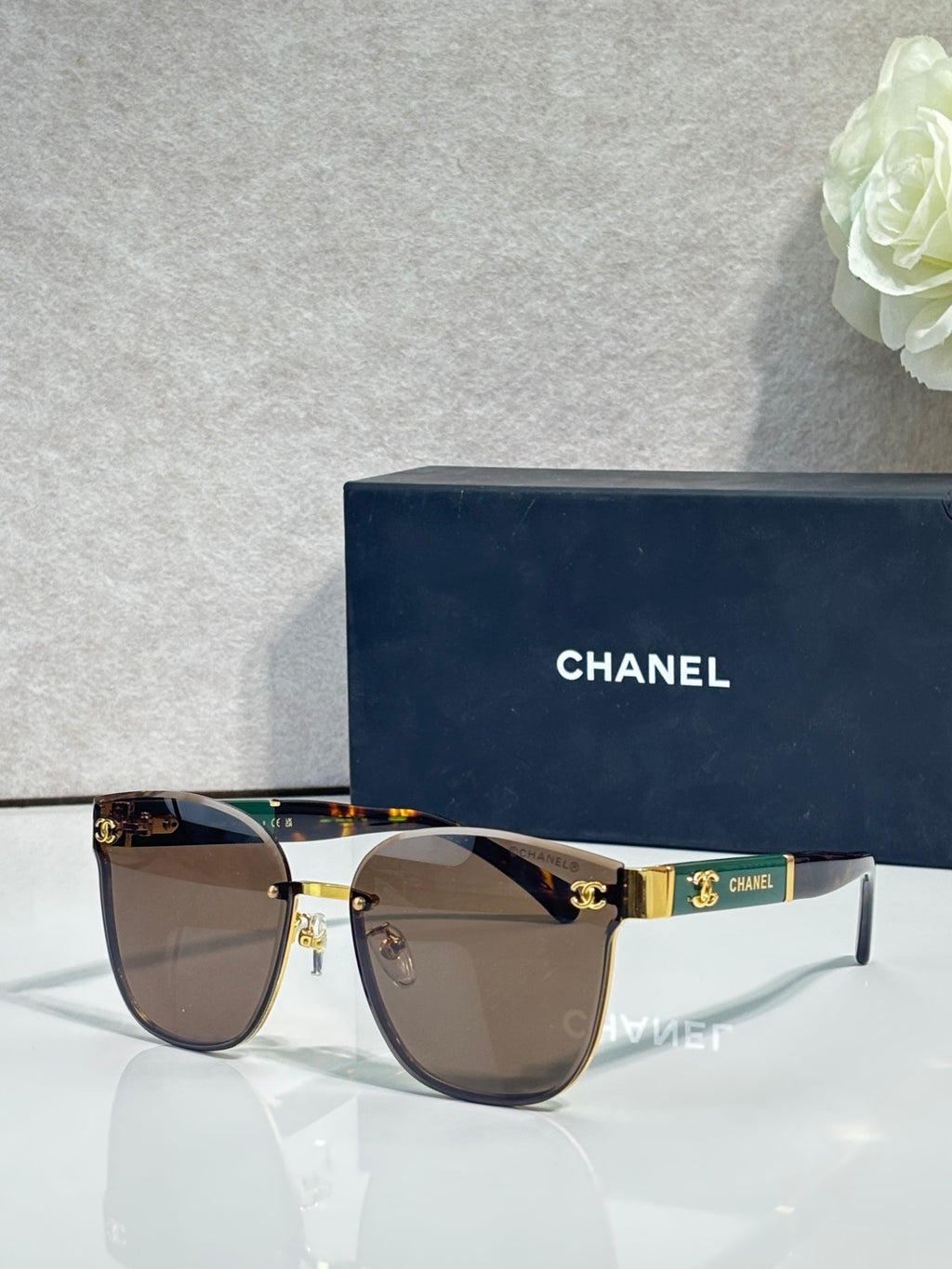 Gold-tone eyeglasses with brown gradient lenses and dark temple accents