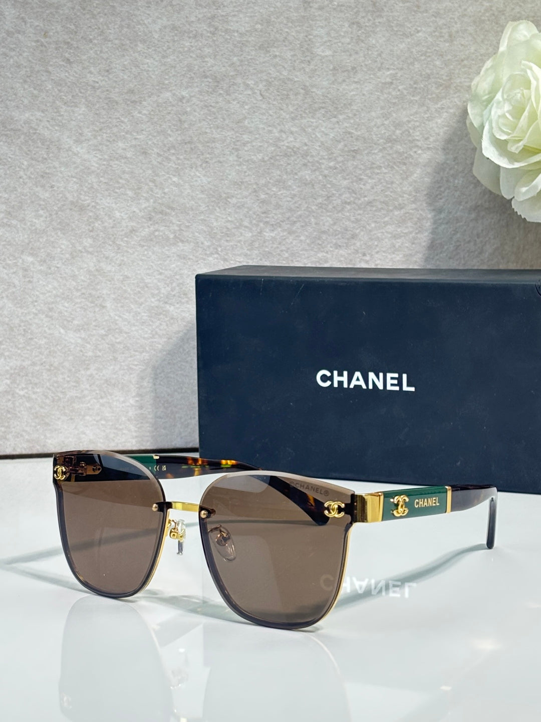Gold-tone eyeglasses with brown gradient lenses and dark temple accents
