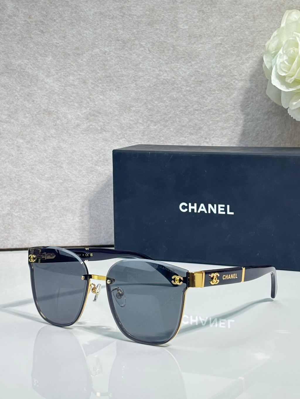 Gold-tone eyeglasses with dark blue gradient lenses and black temple tips