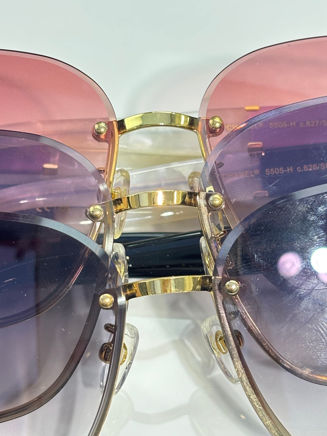 Pink and lavender gradient eyeglasses with gold bridge and front rivets