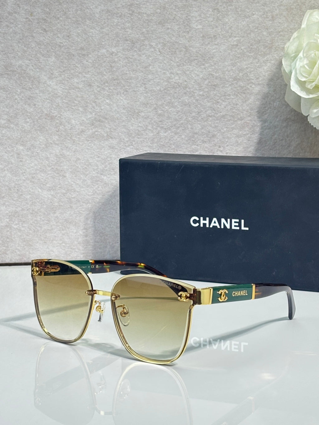Gold-tone eyeglasses with clear lenses and dark blue temple accents