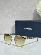 Gold-tone eyeglasses with clear lenses and dark blue temple accents