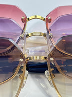 Chanel sunglasses close-up with pink and purple gradient lenses and gold-tone bar bridge