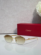 Gold-tone metal sunglasses with light brown lenses and round-oval shape