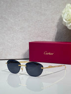 Gold-tone metal sunglasses with dark lenses and round-oval shape