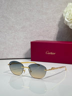 Gold-tone metal sunglasses with gradient blue-gray lenses and round-oval shape