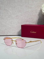 Gold-tone metal sunglasses with pink tinted lenses and round-oval shape