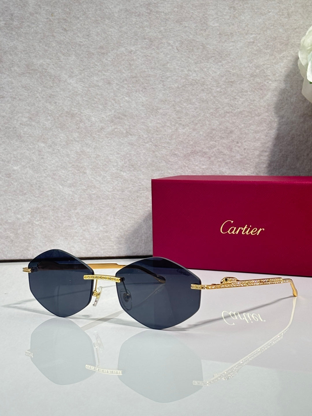 Aviator sunglasses with gold-tone metal frame and dark blue tinted lenses