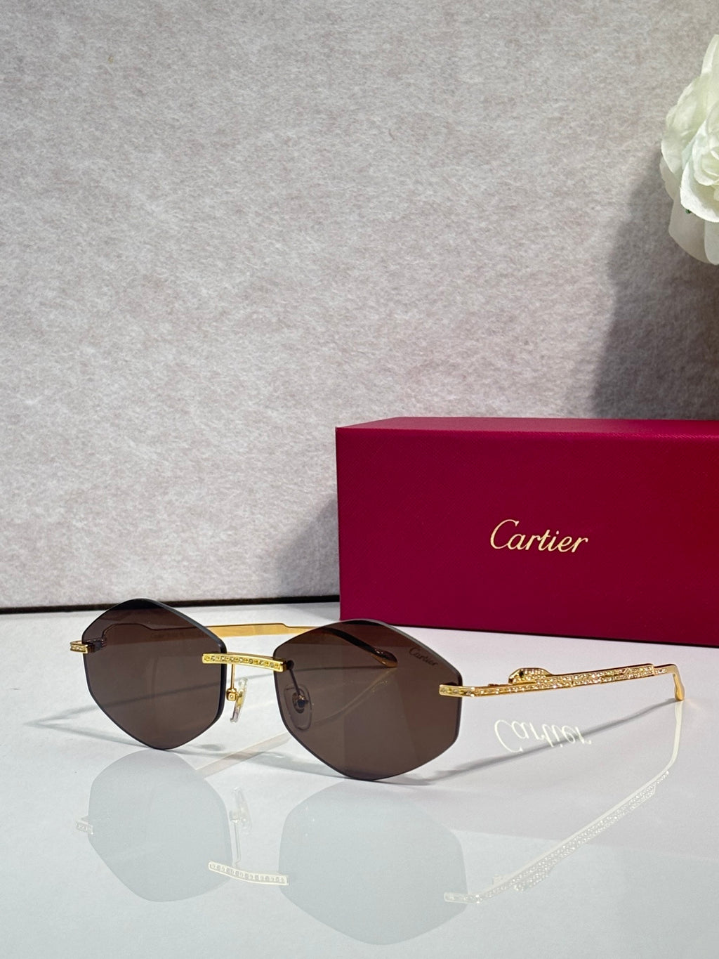 Aviator sunglasses with gold-tone metal frame and dark brown tinted lenses