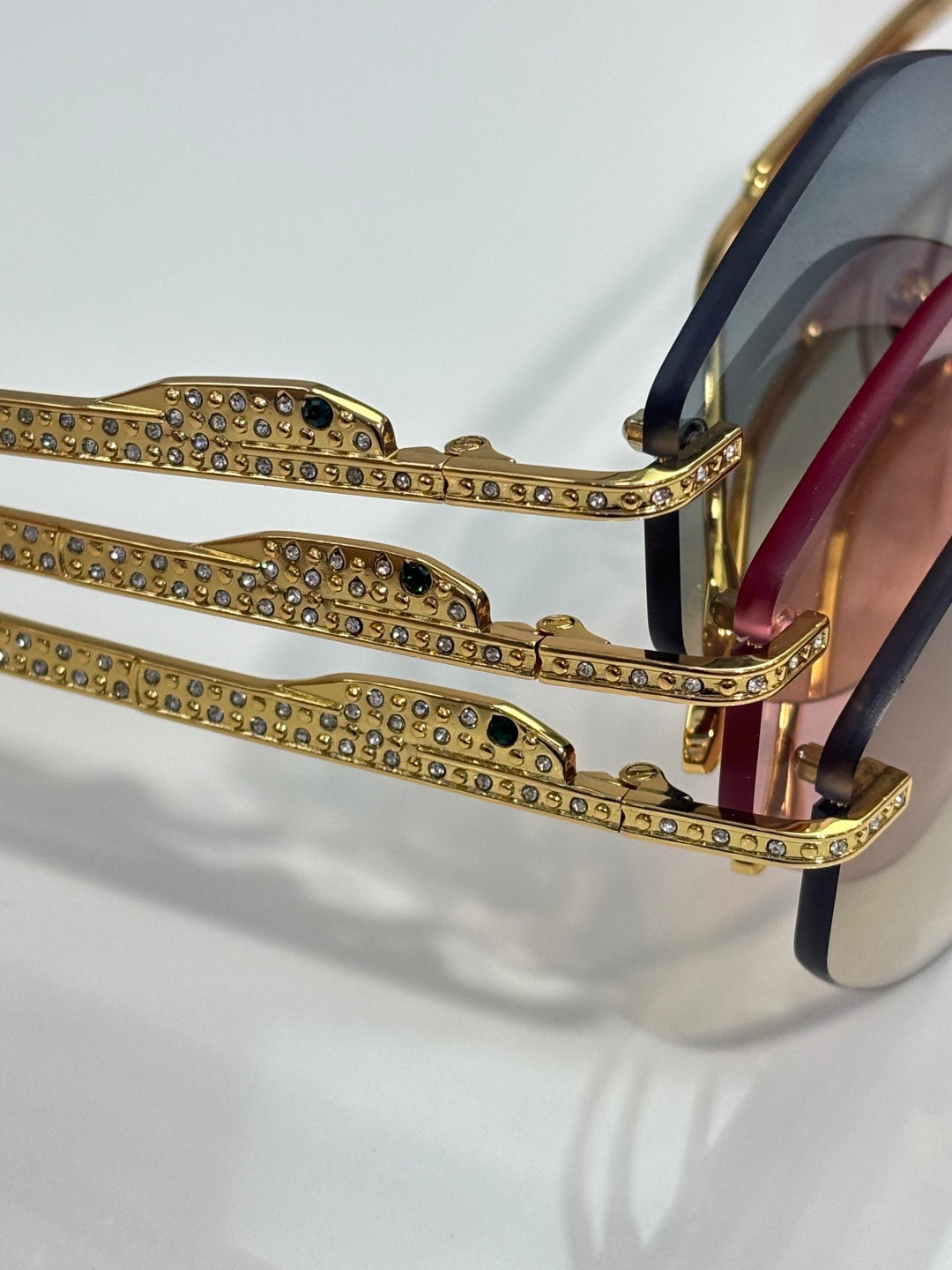 Rhinestone-adorned gold-tone aviator frames with dark blue temple