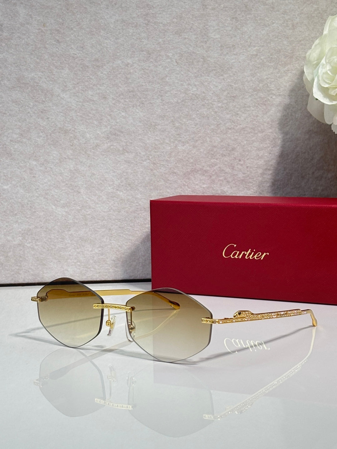 Aviator sunglasses with gold-tone metal frame and pale amber tinted lenses