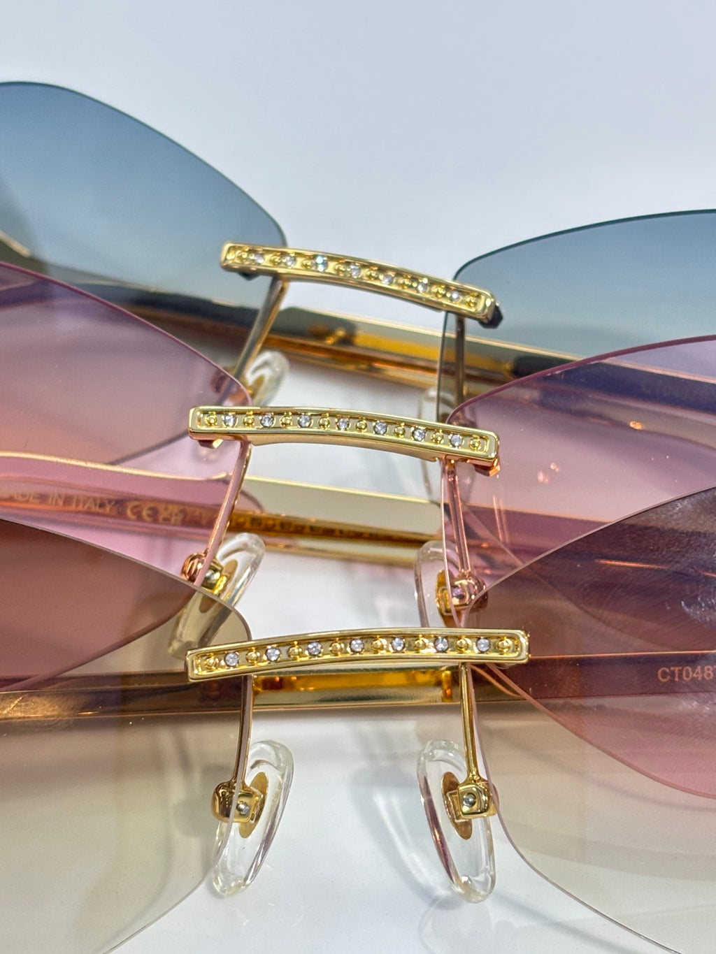 Rhinestone top bar on gold-tone aviator glasses with multicolor tinted lenses