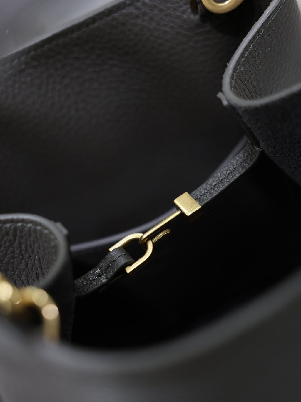 YSL dark bag interior with gold-tone clasp hardware and black strap adjuster