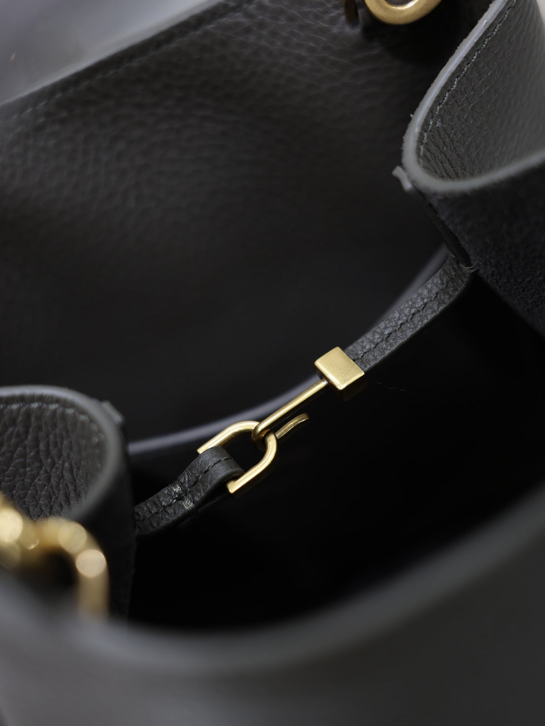 YSL dark bag interior with gold-tone clasp hardware and black strap adjuster