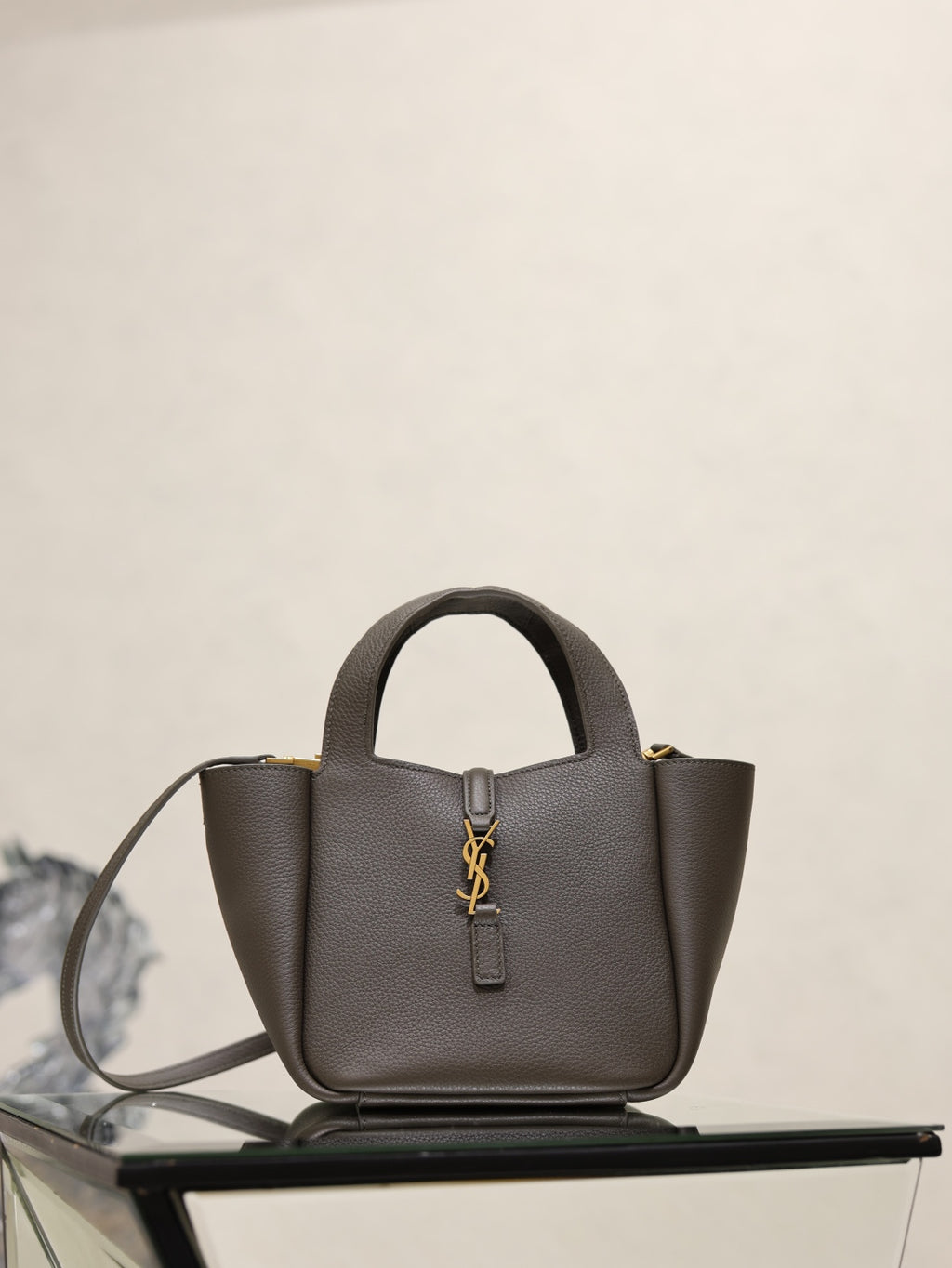 YSL dark leather top-handle bag with gold-tone YSL logo and detachable shoulder strap