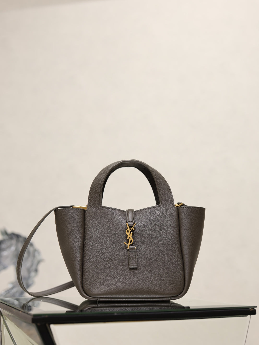 YSL dark leather top-handle bag with gold-tone YSL logo and detachable shoulder strap