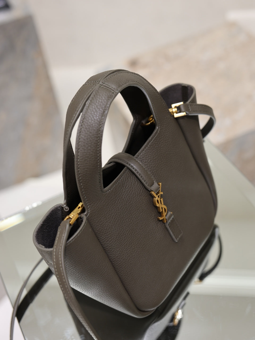 YSL dark leather mini bag, front clasp with gold-tone YSL emblem, top handle