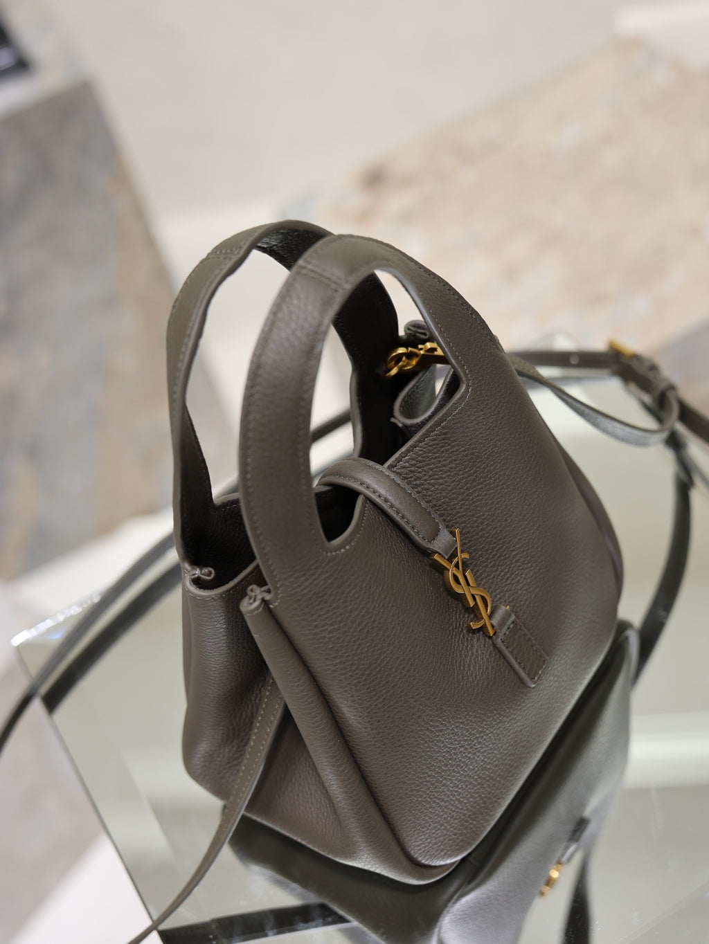 YSL dark leather mini bag with top handle and shoulder strap, gold-tone hardware